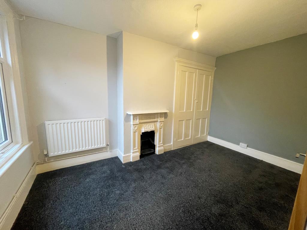 Lot: 11 - WELL PRESENTED THREE-BEDROOM HOUSE - Bedroom with fireplace